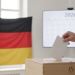 A person casting a ballot into a box for the 2026 German municipal elections.
